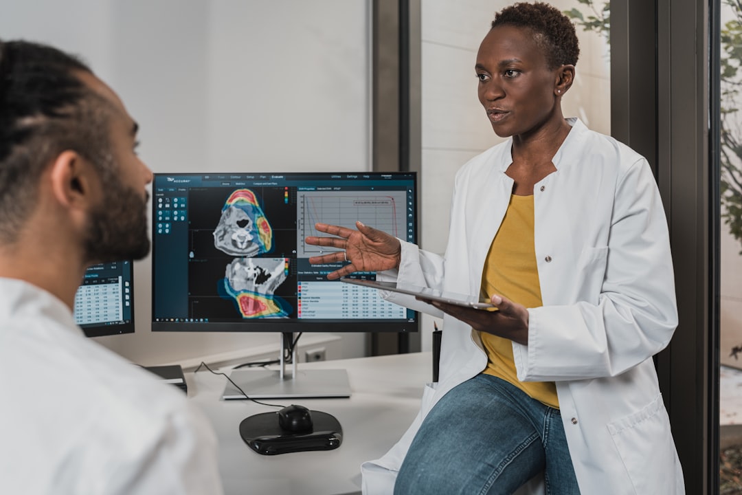 Clinician reviewing medical imaging on a digital platform alongside patient records