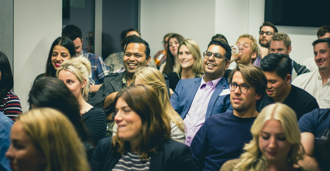 Business owners listening to a speaker at an AI and cybersecurity workshop