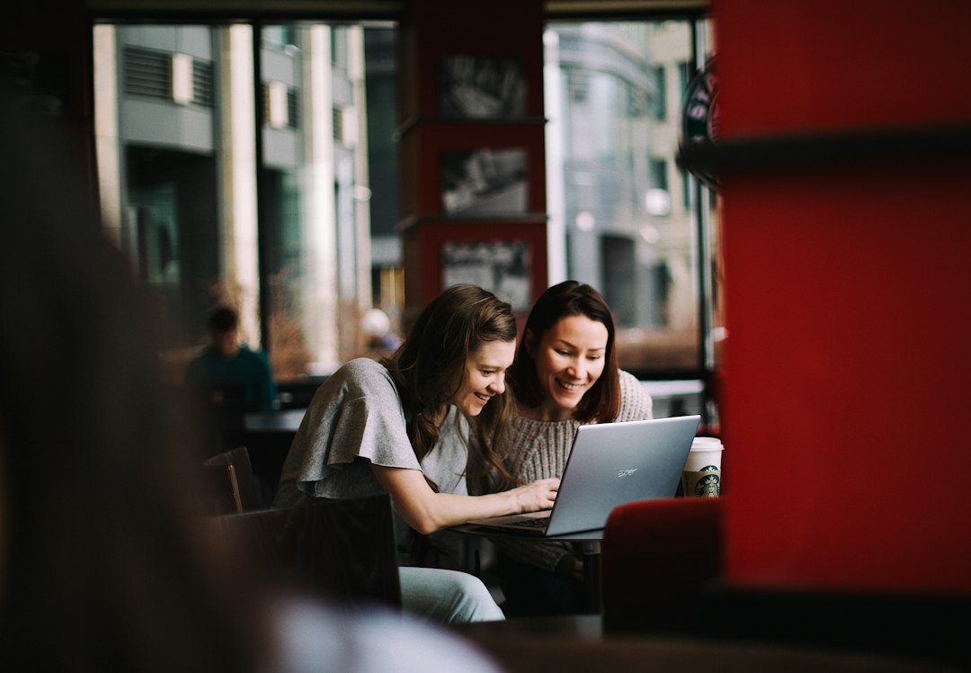 Team of small business owners collaborating with AI and cybersecurity tools on a laptop