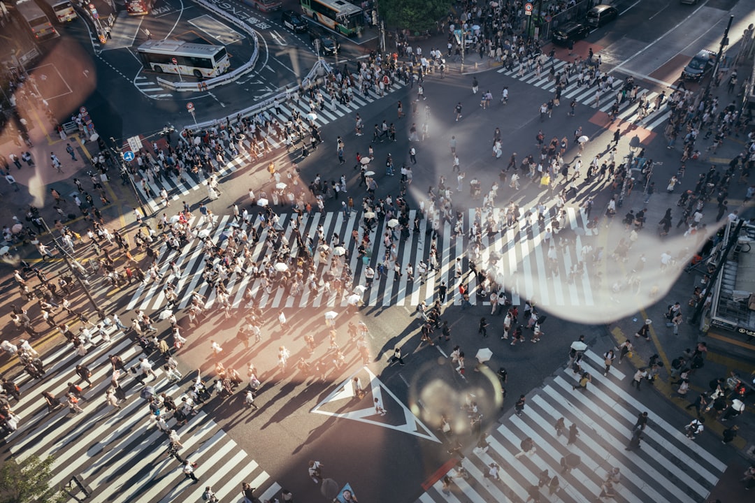 A diverse group of people overlaid with AI and data icons representing the impact of artificial intelligence on society