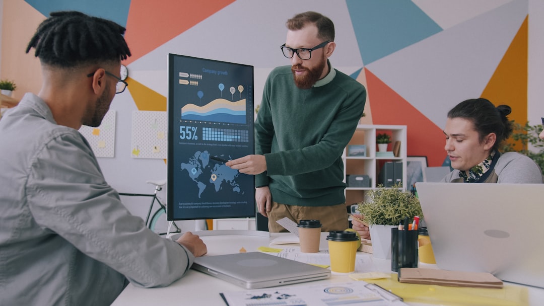 Marketing team reviewing AI-powered analytics dashboard on a screen