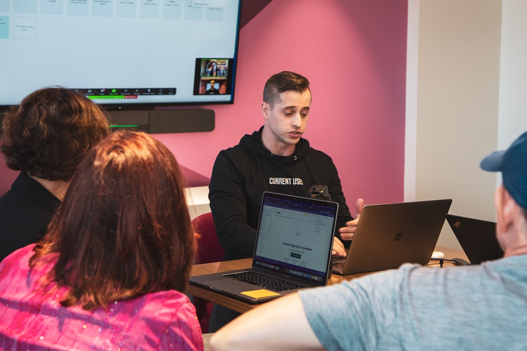 Small business owners participating in an AI training workshop with laptops