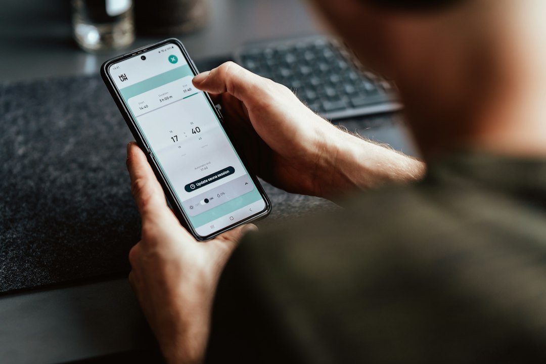 Patient having their hand scanned with an AI-powered mobile app during a musculoskeletal exam