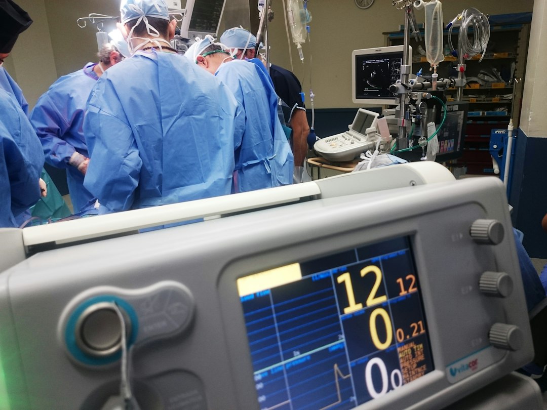 Medical team discussing AI hand and wrist scan results in a modern clinic setting