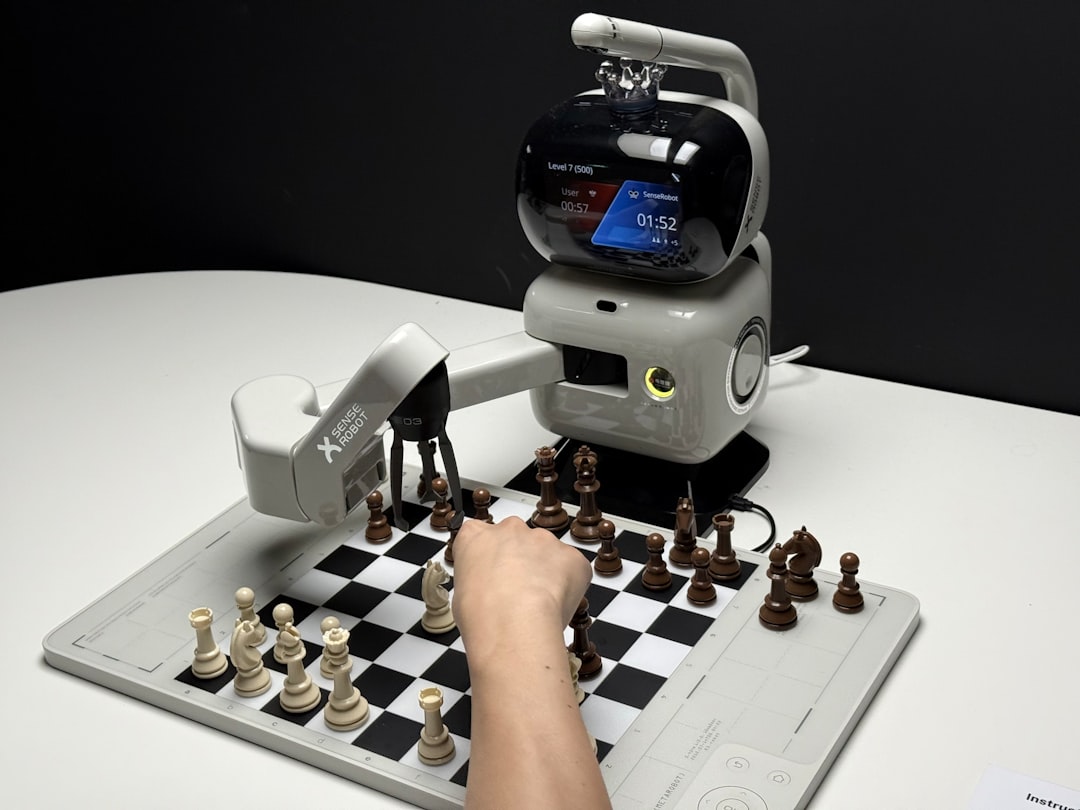 Human sitting on a sofa beside a small social robot, both facing forward