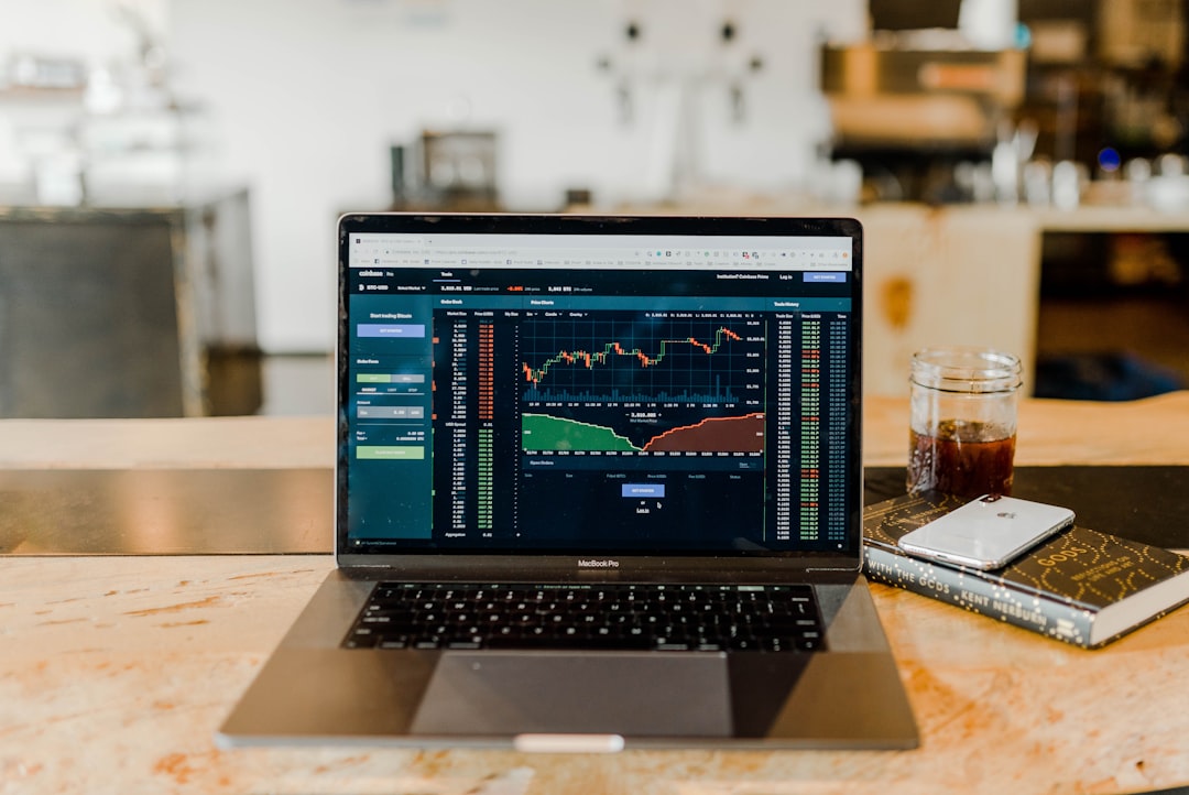 Financial analyst using laptop with spreadsheets and AI tools