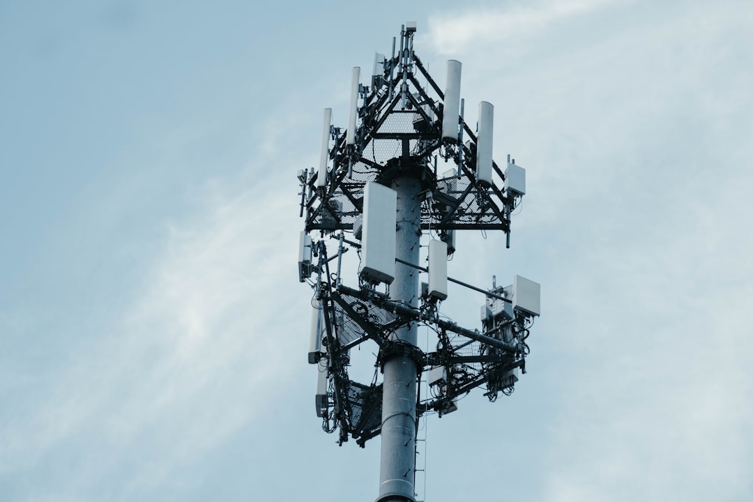 5G base station tower connected to an AI-driven edge computing node