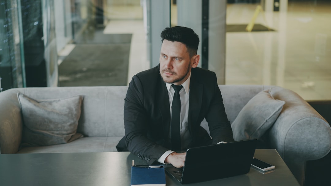 Business owner comparing CRM options on a laptop