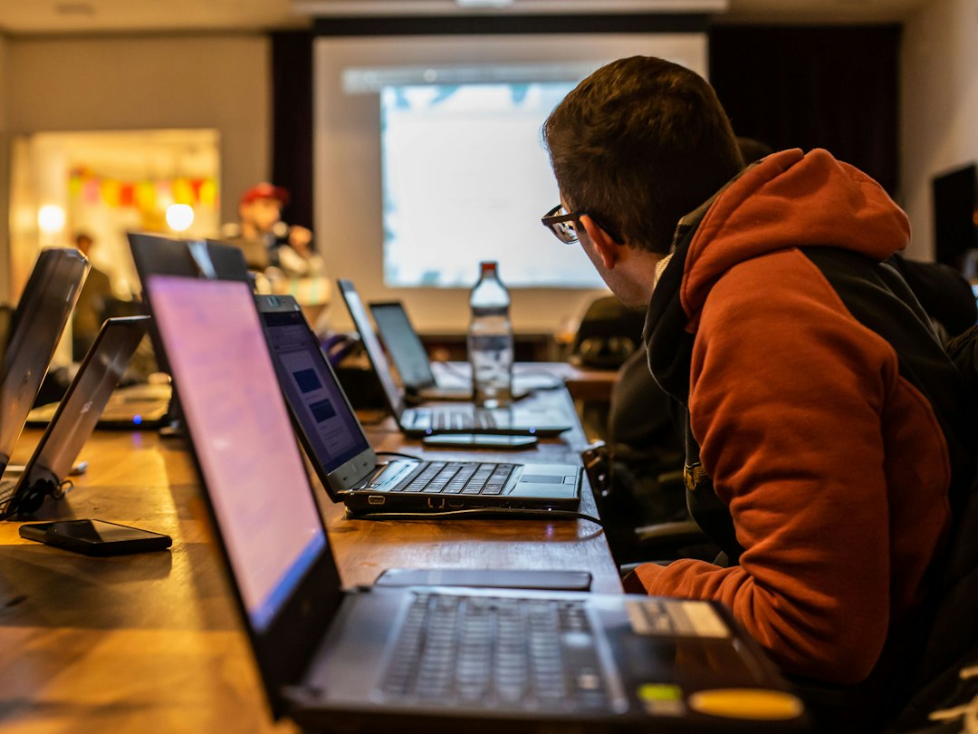 Business students working on laptops in a technology-enabled classroom