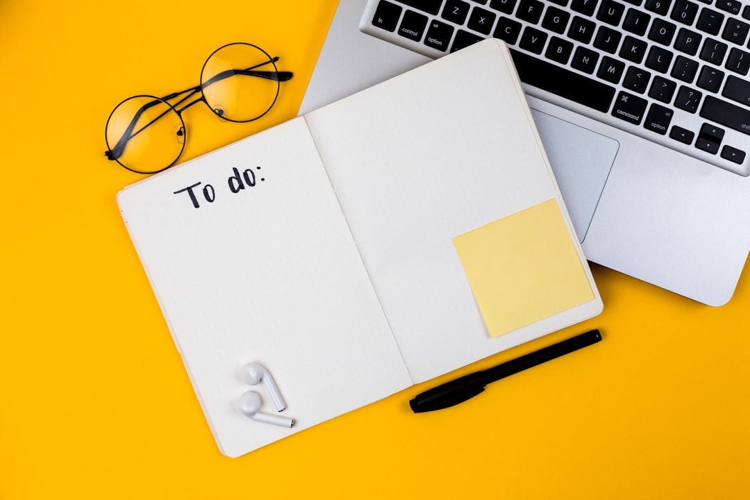 Freelancer planning a roadmap using a laptop and notebook