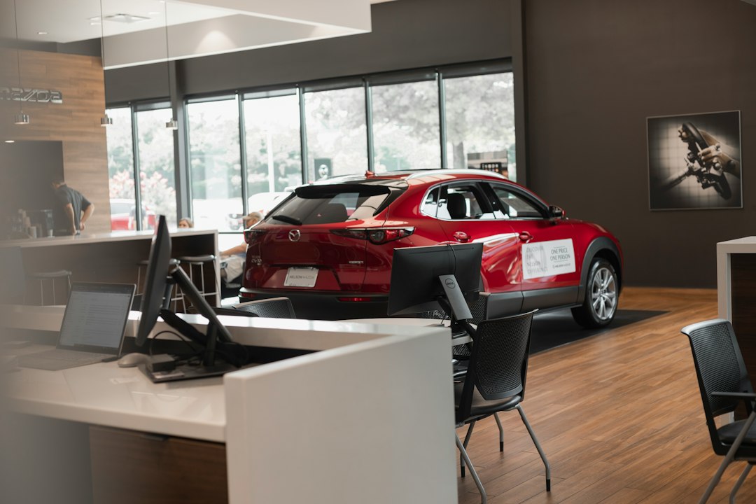 Dealership sales team reviewing sales reports and digital dashboards