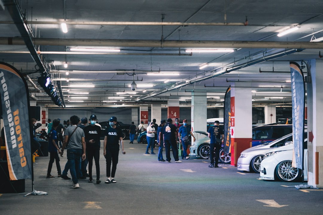 Sales manager coaching a car salesperson while reviewing performance metrics
