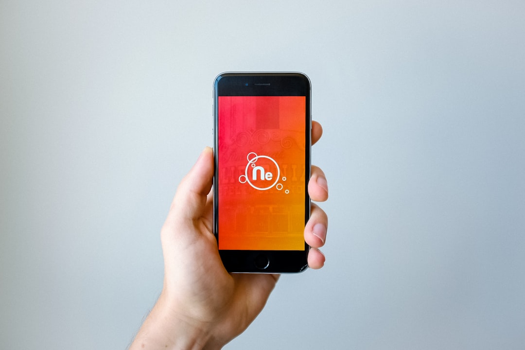 Neurodivergent person using a focus app on a smartphone while working at a desk