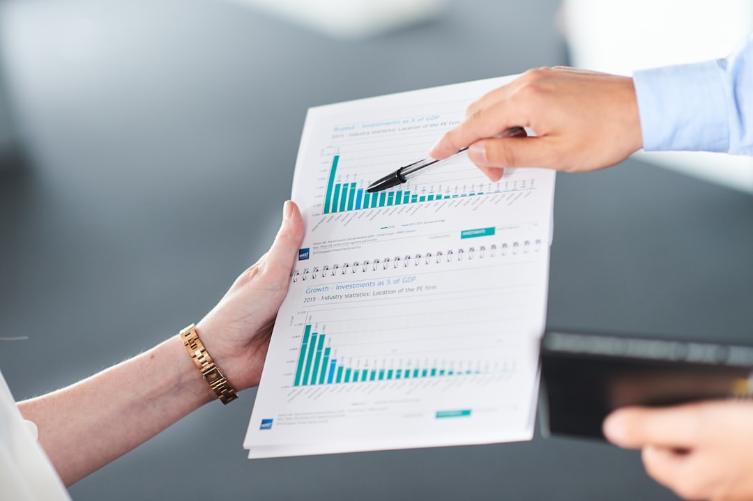 Team analyzing data in spreadsheets with AI assistance during a business meeting