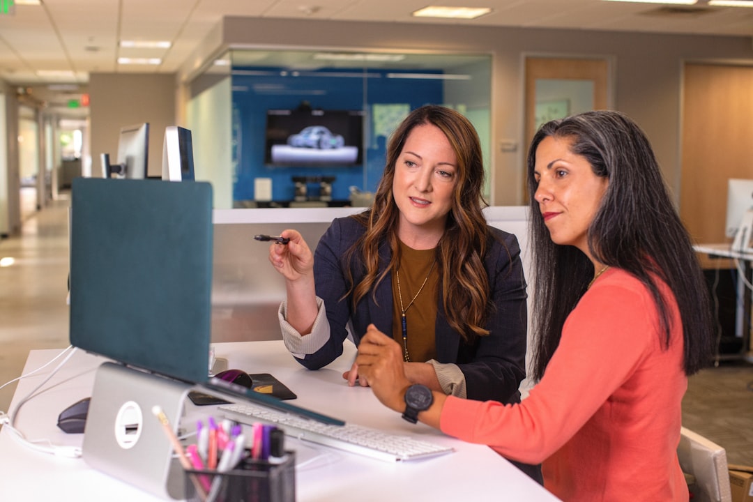 Employees collaborating around a digital portal interface in an office