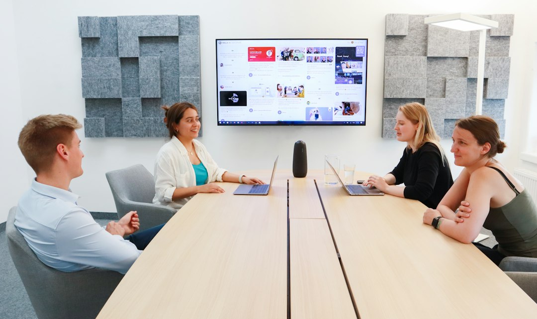 Group of small business owners planning strategy around a laptop