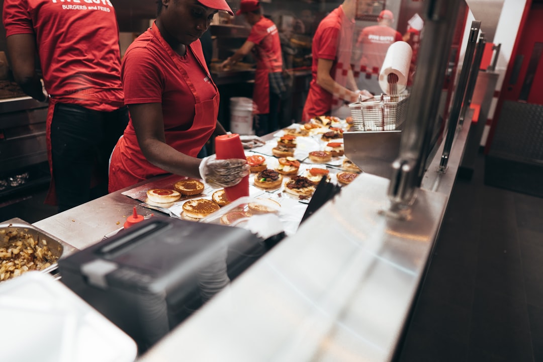 Busy fast-food restaurant counter with customers ordering promotional meals