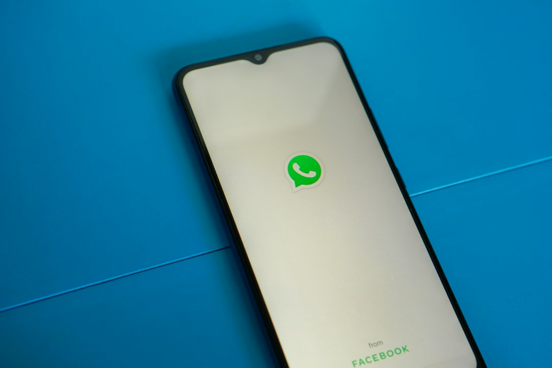 African entrepreneur using WhatsApp on a smartphone to manage business conversations