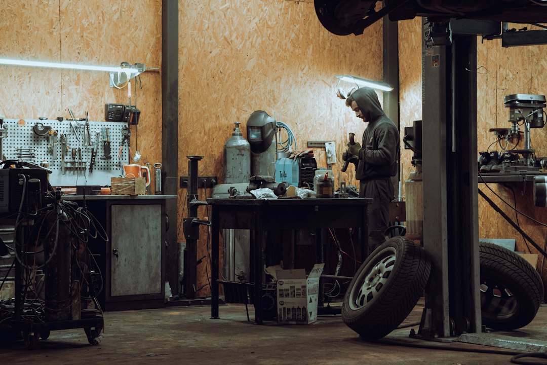 Technician servicing a forklift in a workshop to ensure reliability