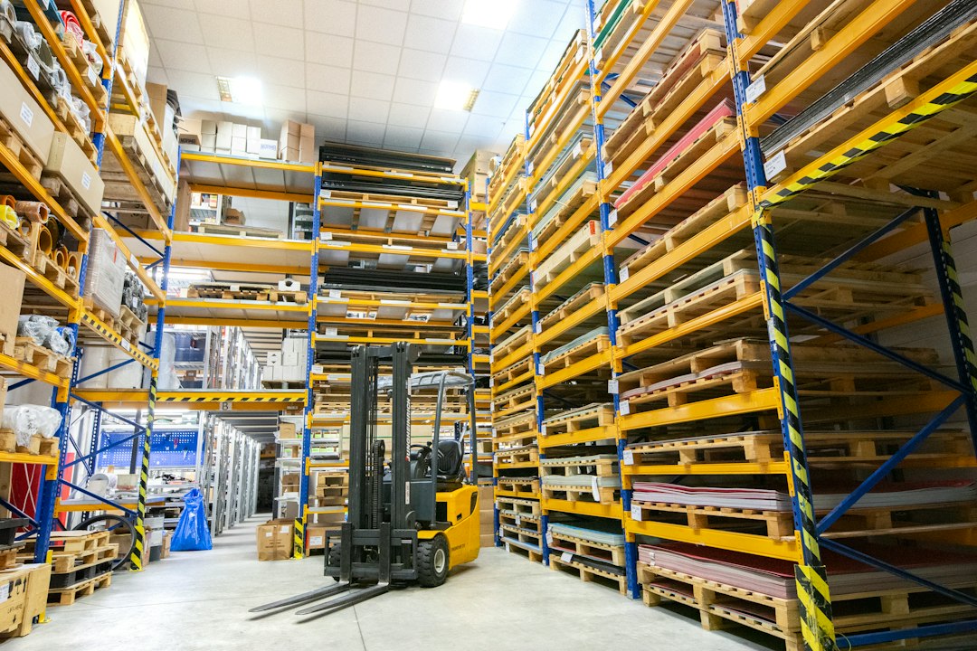Warehouse manager reviewing forklift fleet performance and maintenance records