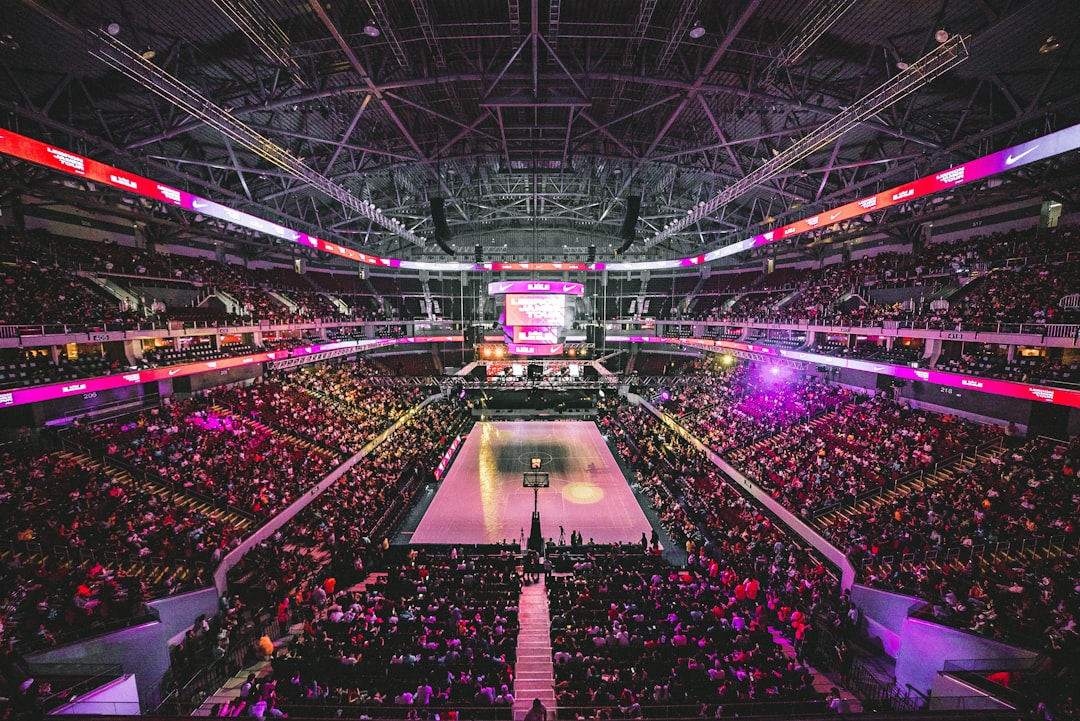 Fans wearing basketball jerseys and waiting in line at an arena