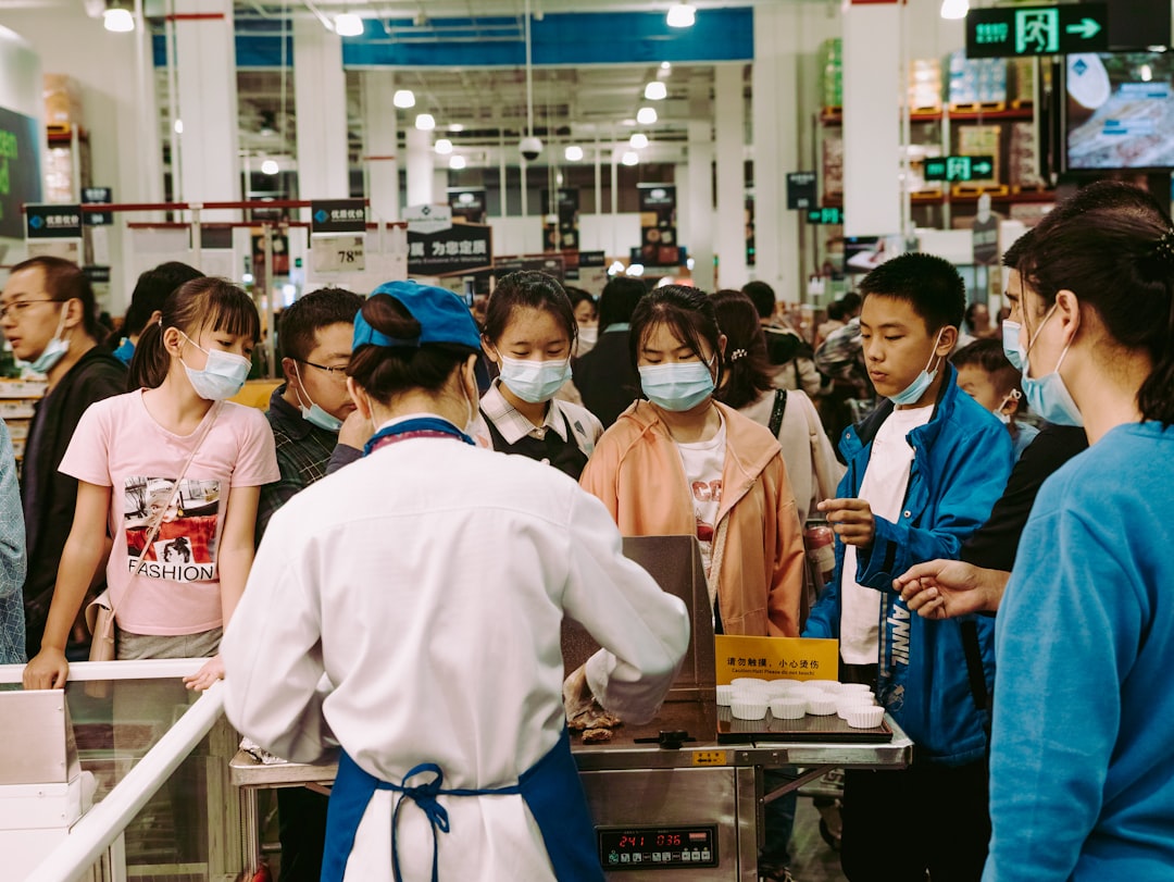 Chinese shopper choosing premium yogurt from a refrigerated shelf