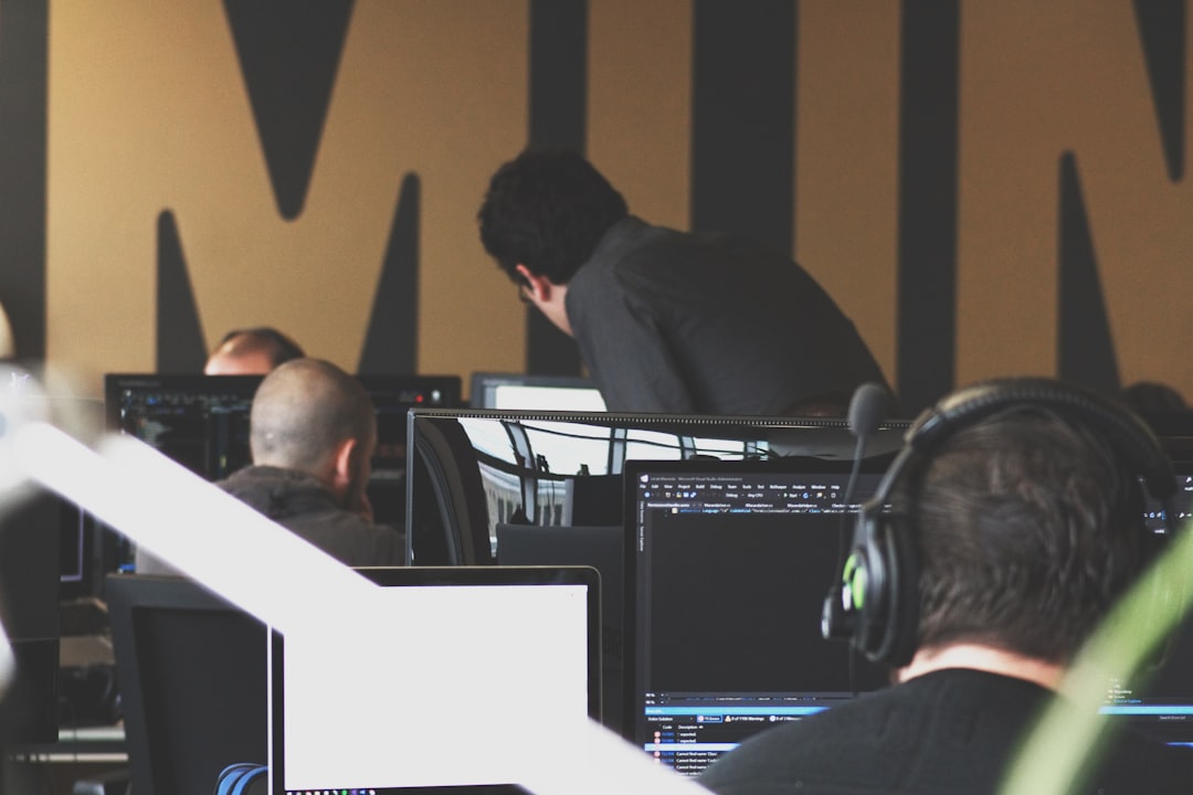 Security operations center monitoring cyber threats on multiple screens
