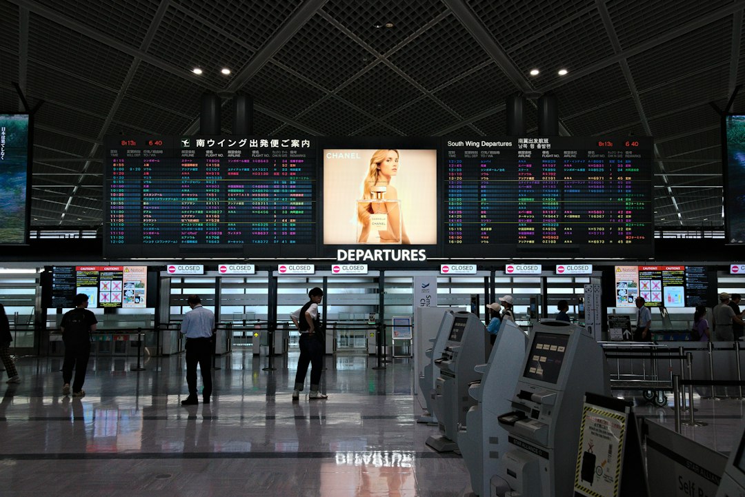 Airline operations control room with multiple screens showing flight data and analytics
