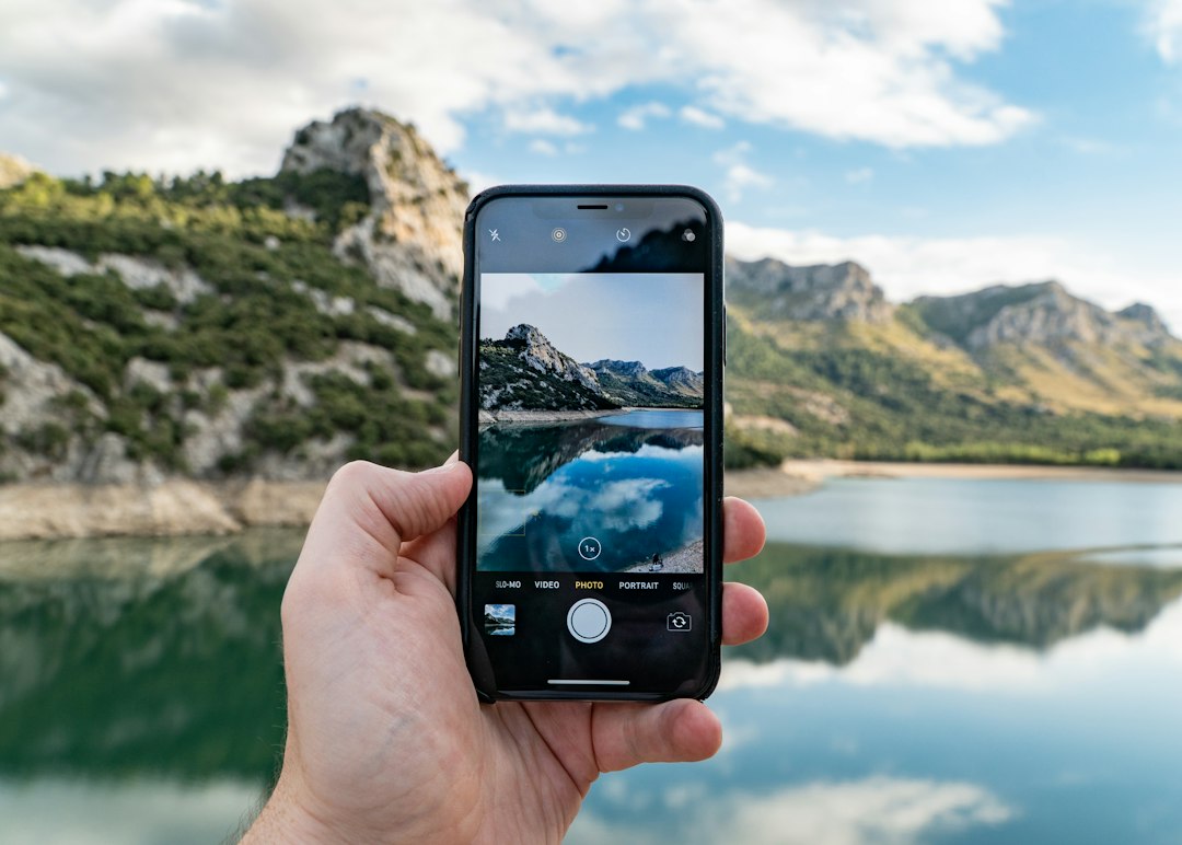 Person taking photos with a modern smartphone in an urban setting