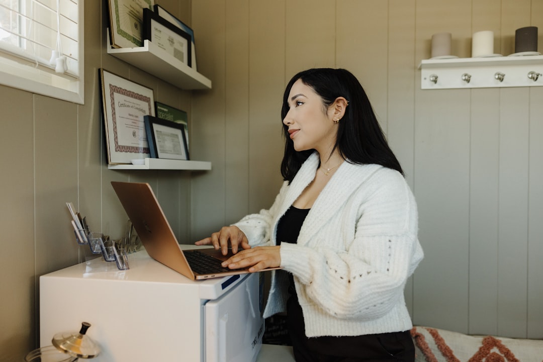 Small business owner using a laptop to update their chamber of commerce profile