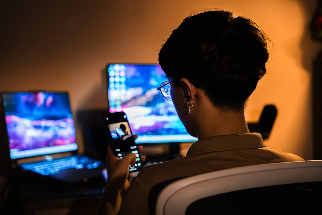 A tech founder working late at night in a minimalist office surrounded by screens