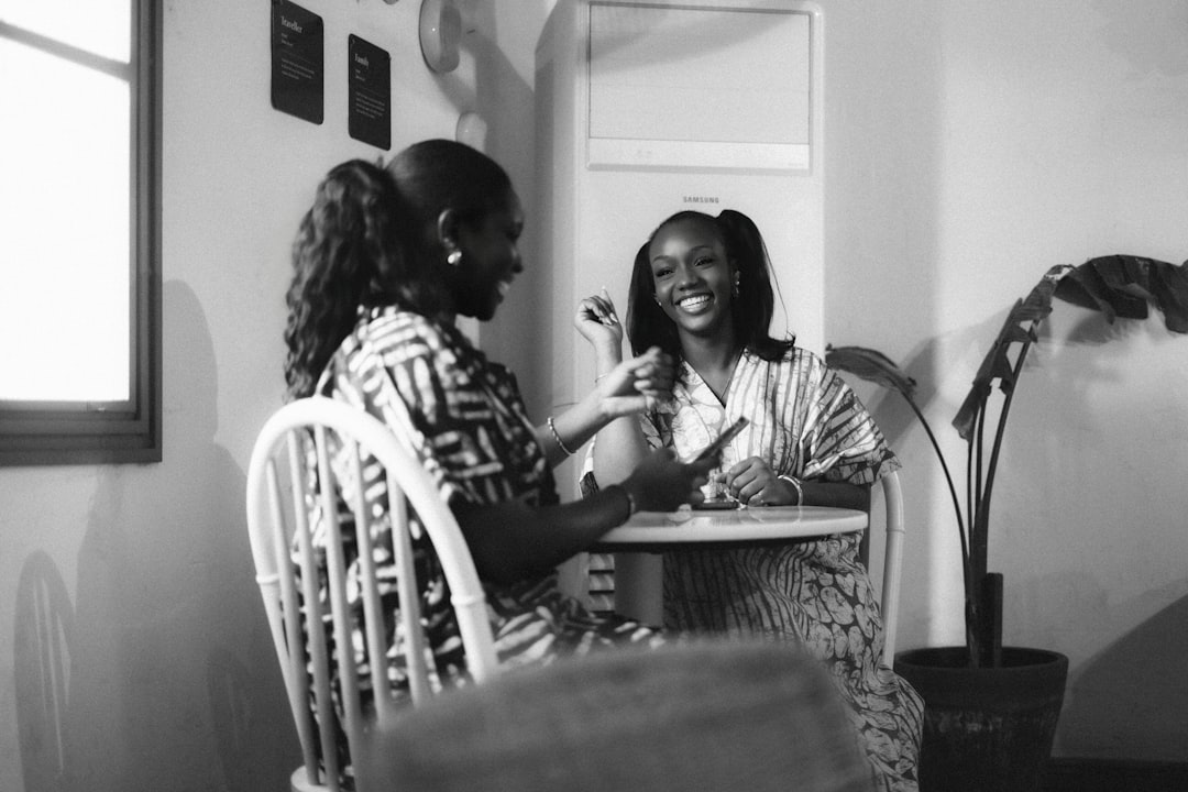 Friends talking and laughing together in a coffee shop, representing relational connection