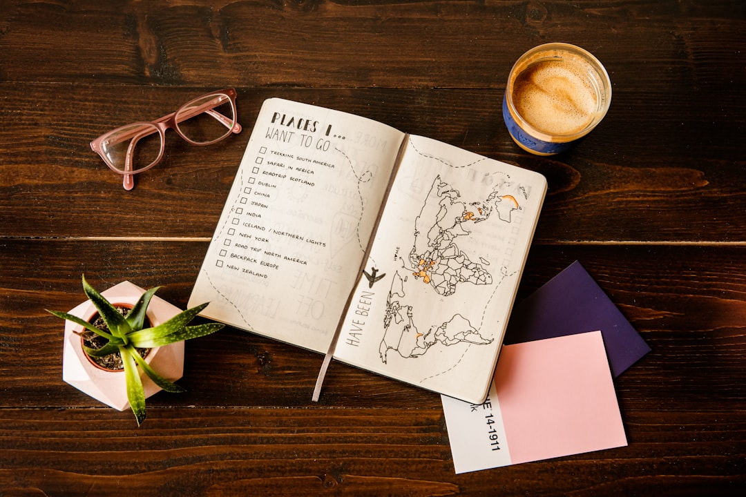 A person journaling with a notebook and coffee, planning a more intentional life