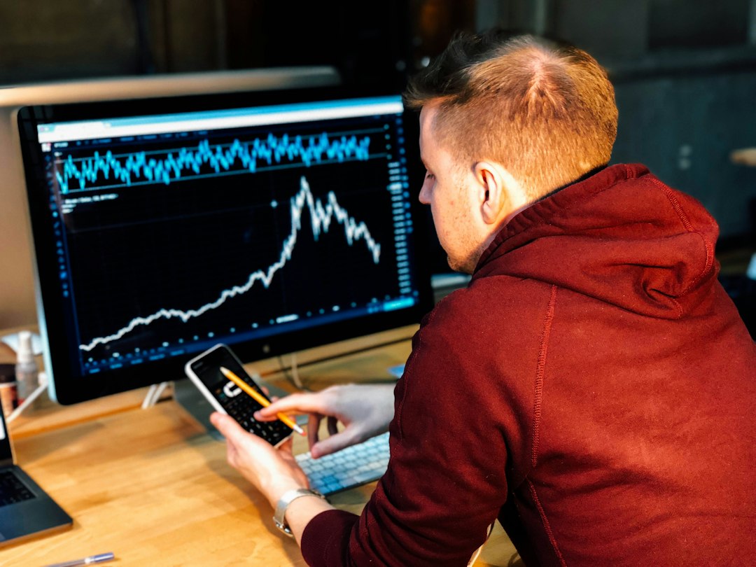 Investor analyzing technology stock charts on a laptop