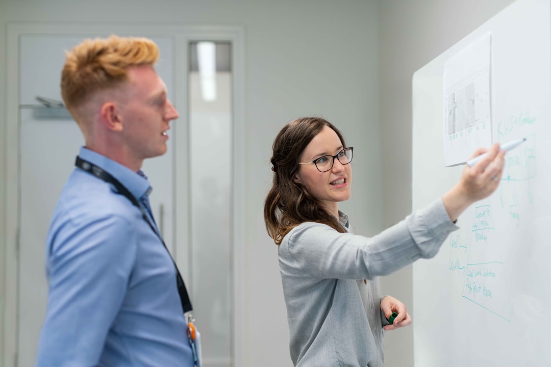 Small business team planning productivity improvements on a whiteboard