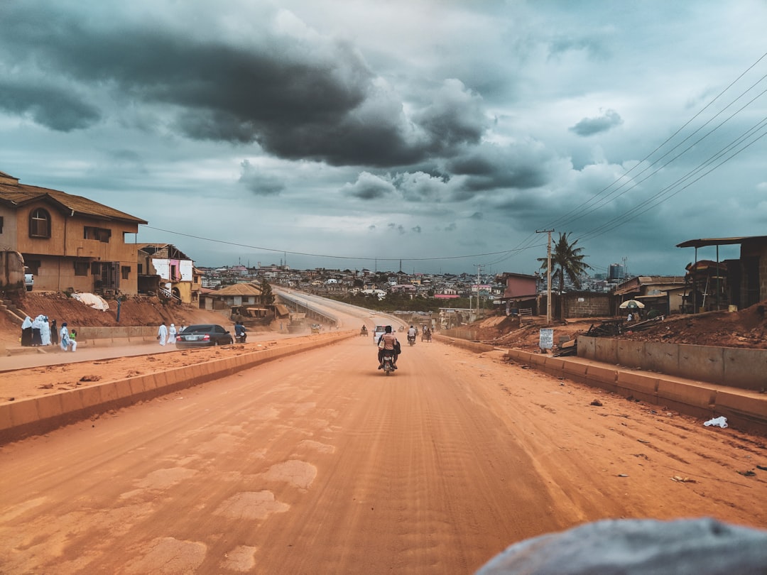 Person holding a modern smartphone on a busy Nigerian street